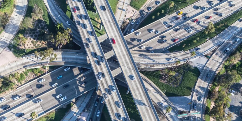 Aerial highway scene showing multiple lanes of traffic and road infrastructure for U.S. transportation networks