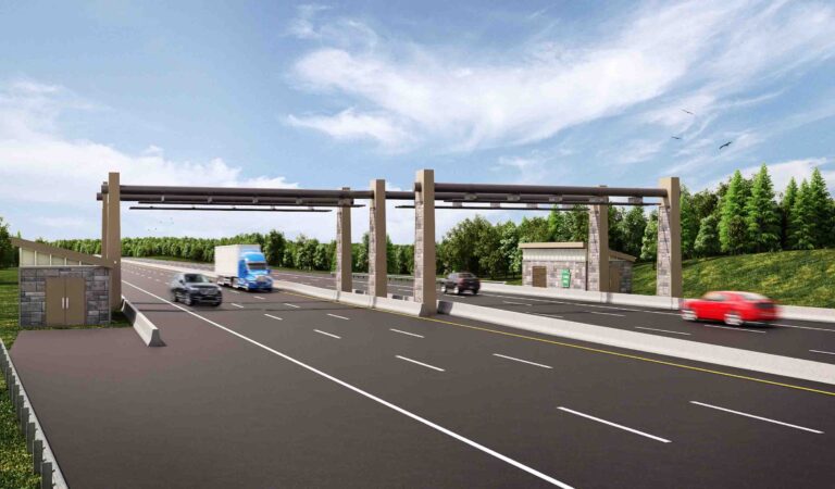 Open-road cashless tolling system with vehicles driving under a highway gantry at speed